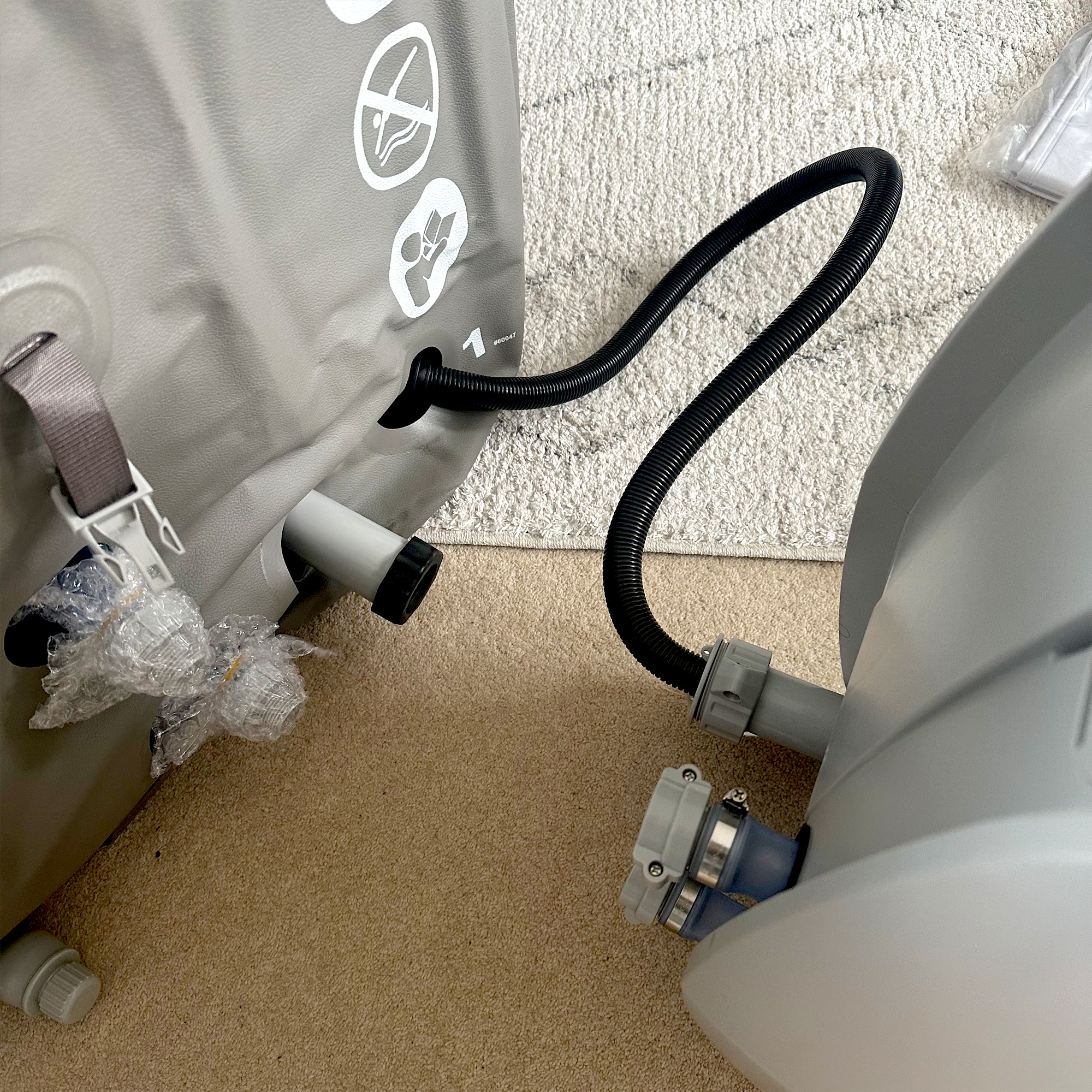 The Lay-Z-Spa Barbados hot tub being assembled in a carpeted living room 