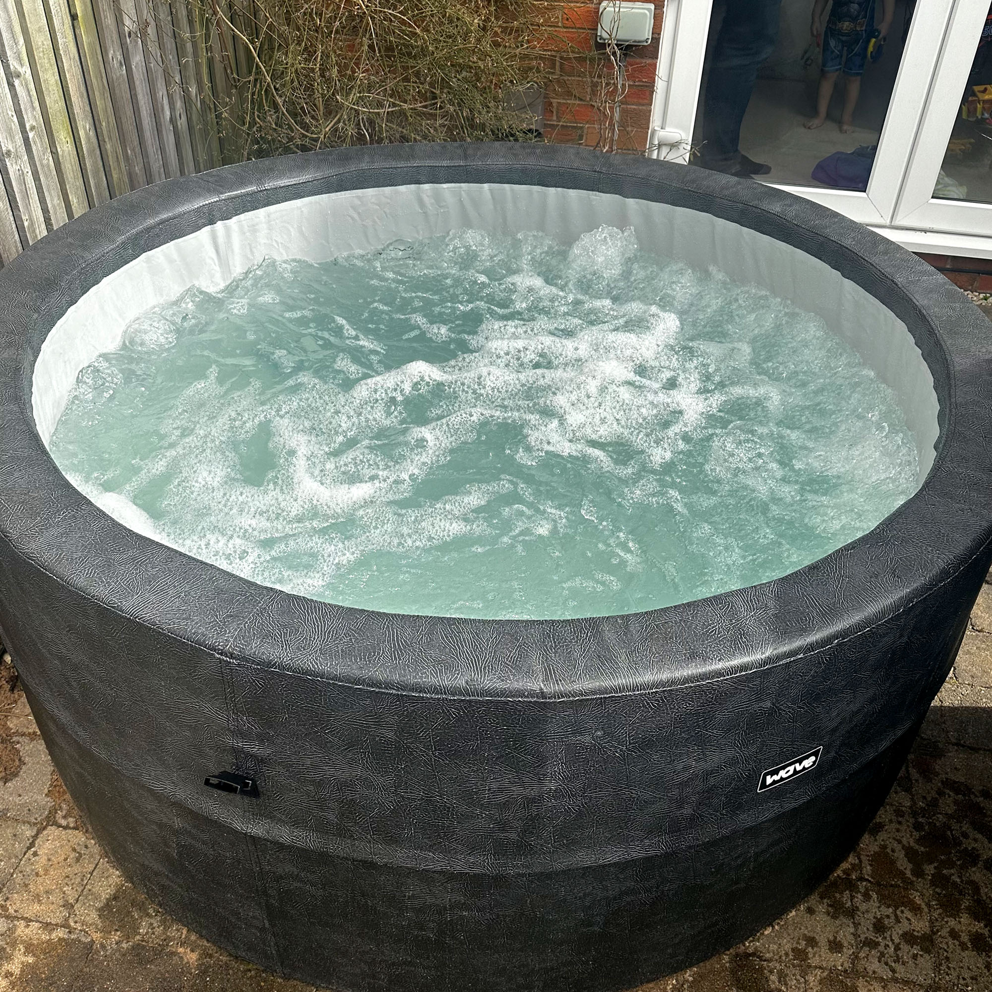 The Wave Osaka hot tub filled with bubbling blue water