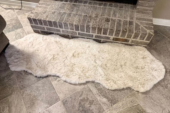 The Rugs USA Waverly Double Faux Sheepskin Rug on a tile floor