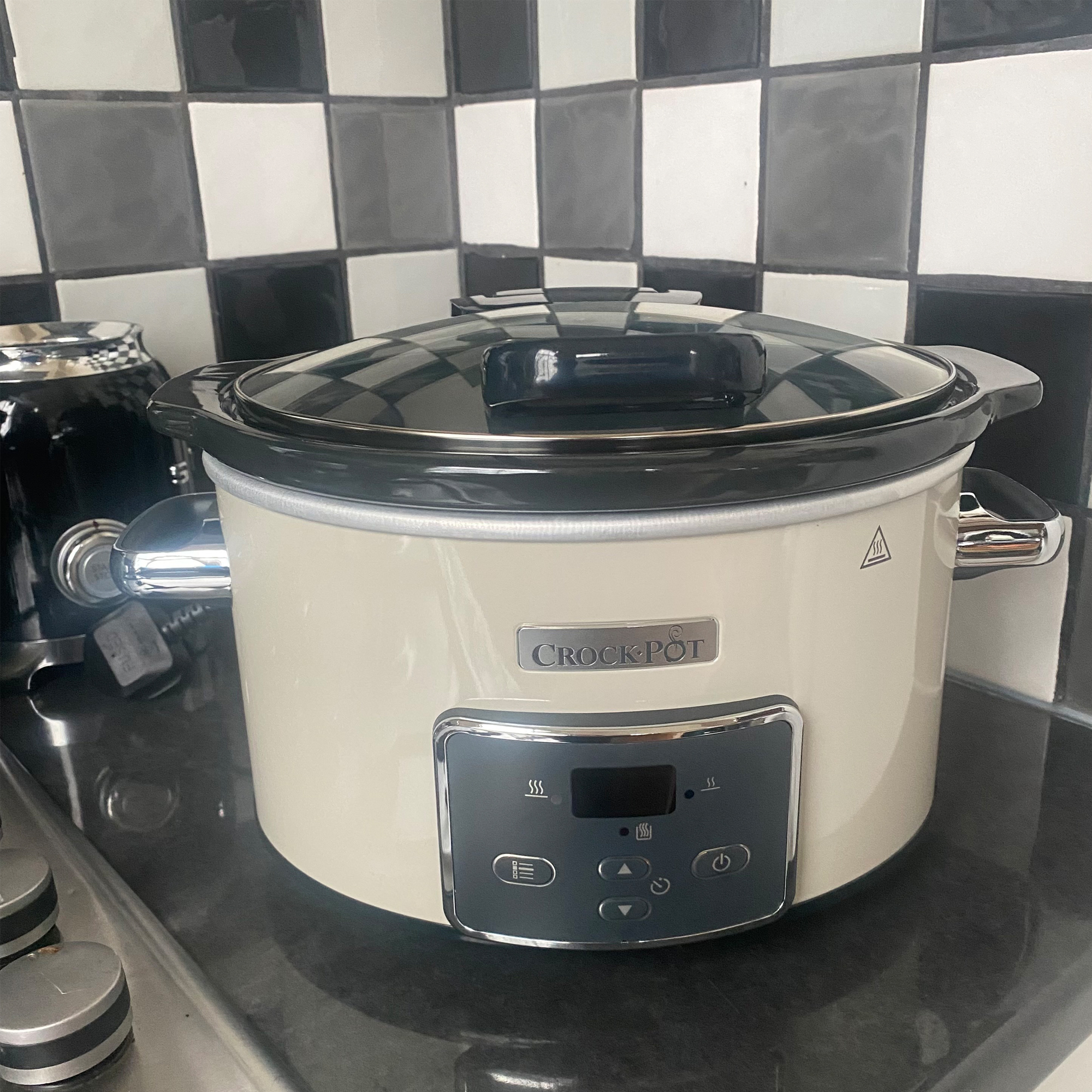 A white CrockPot slow cooker on kitchen side 