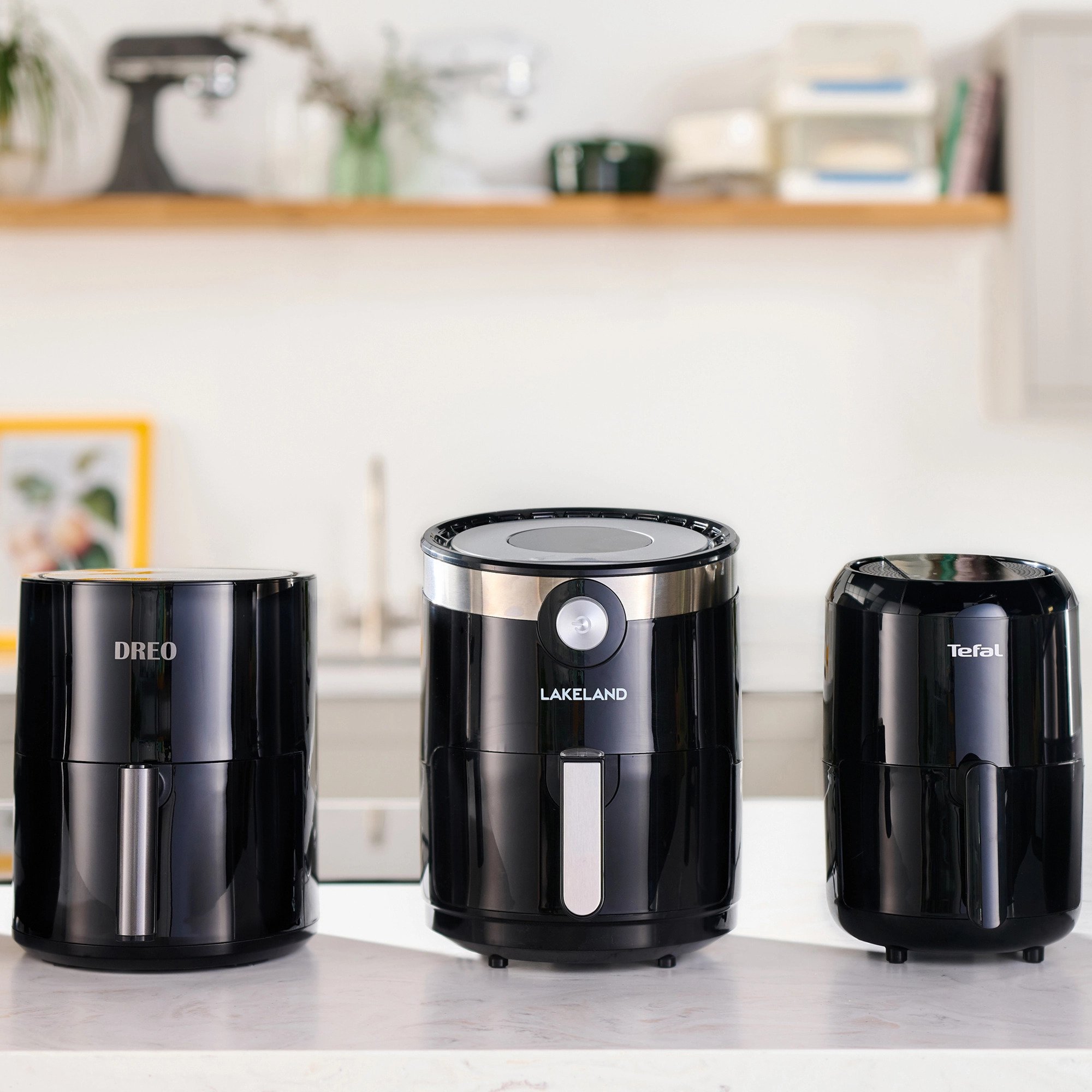3 black air fryers in a line