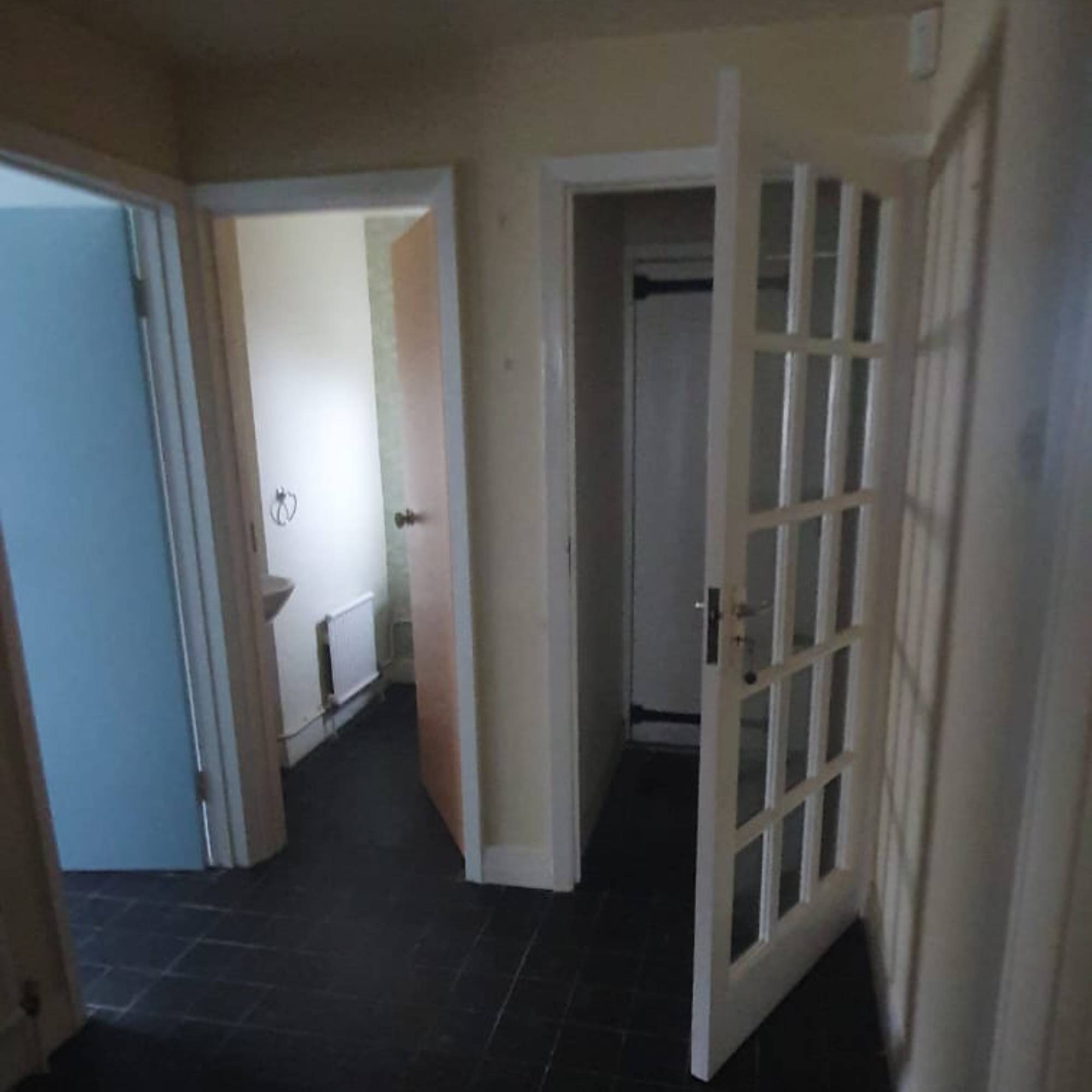 dark porch area with black floor and open glass door