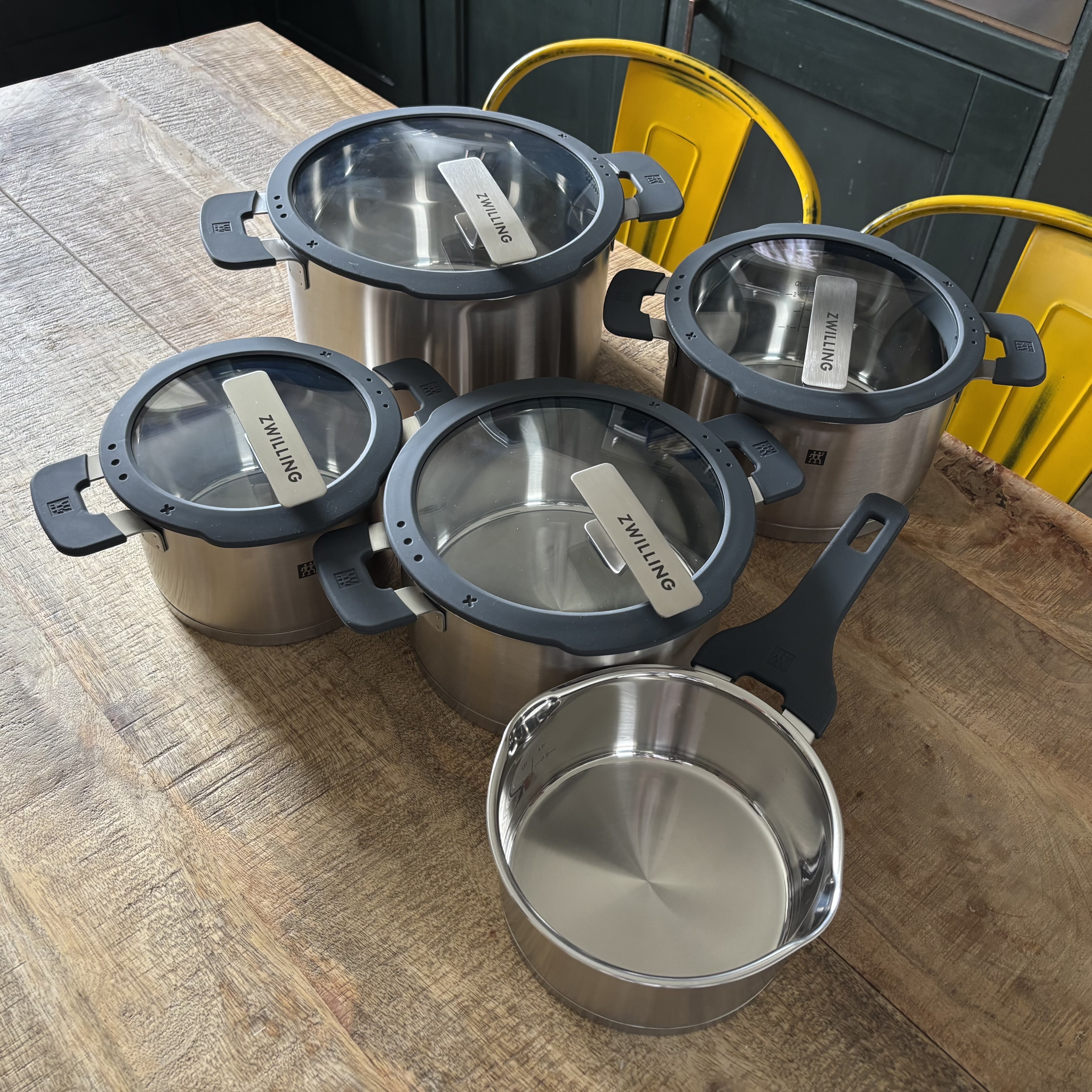 The Zwilling Simplify Pot Set displayed on a wooden kitchen table.