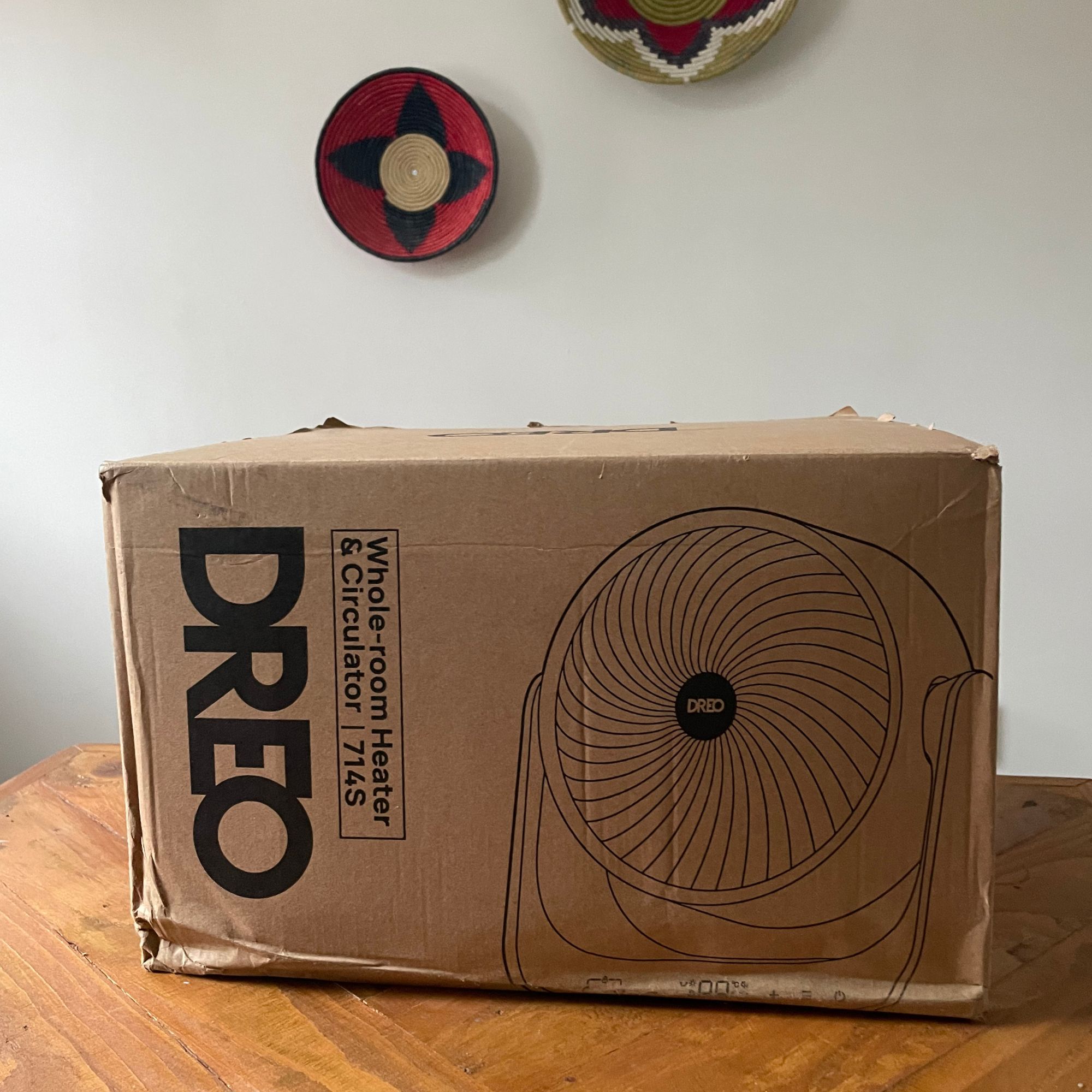 Box of the Dreo Smart Whole Room Heater 714S sitting on wooden table
