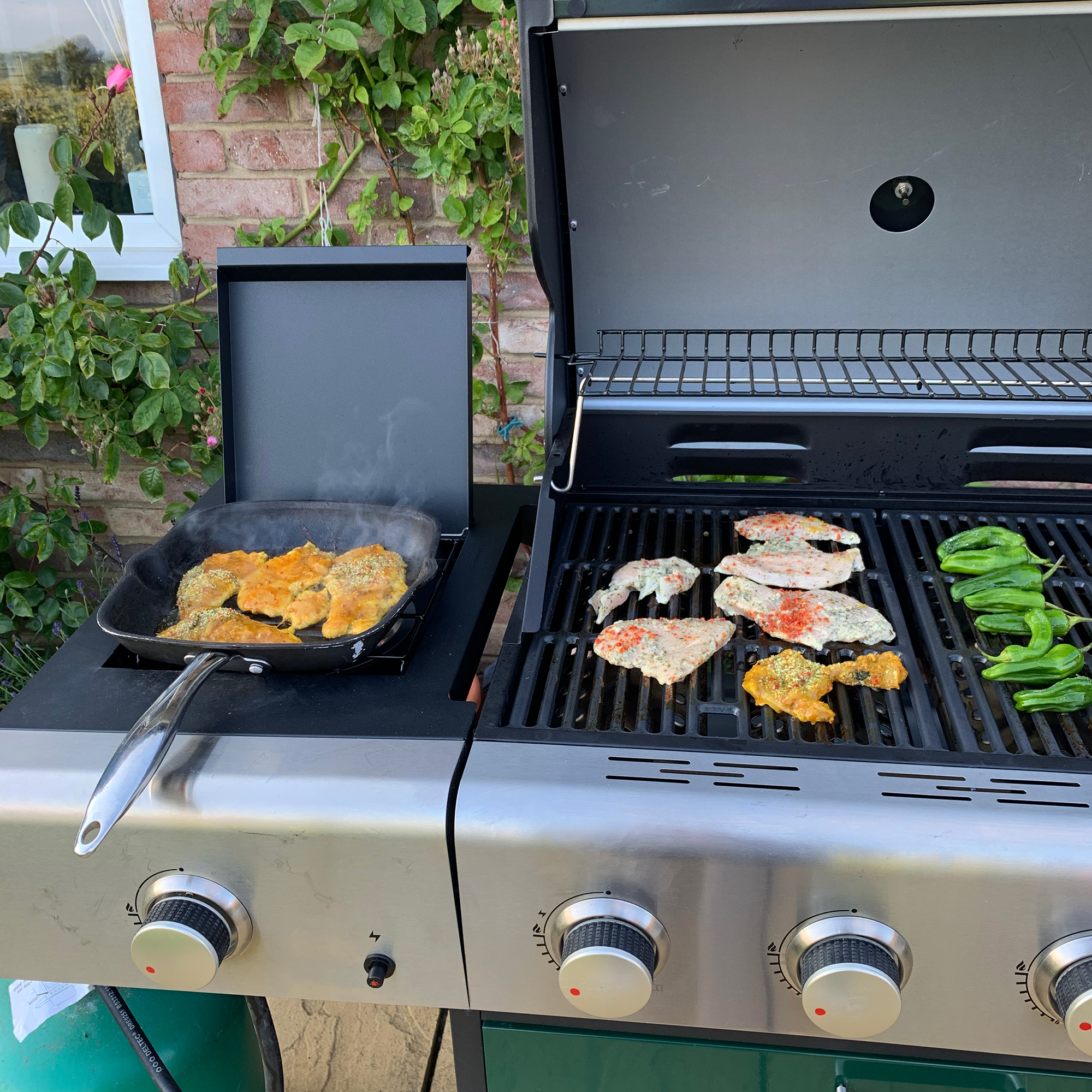Green BBQ with sausages on grill