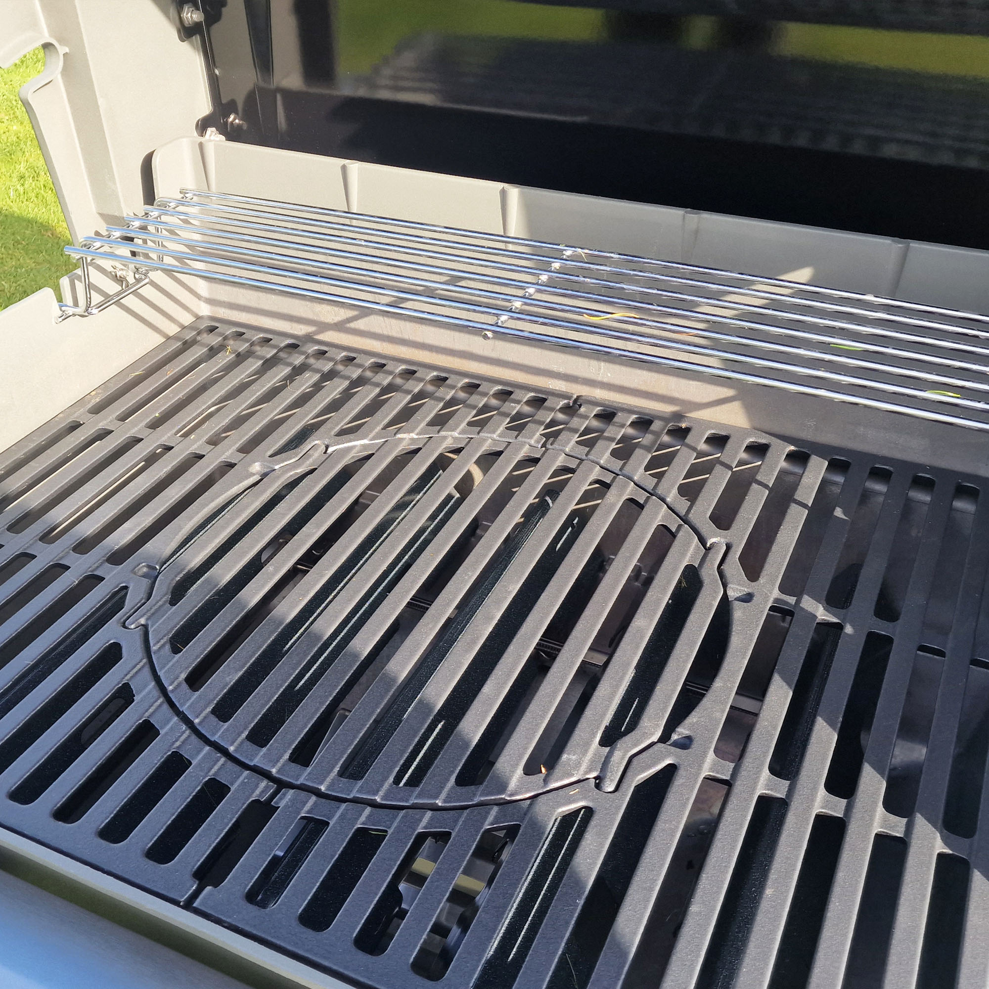 Weber Spirit II E-310 gas barbecue being tested on a grass lawn