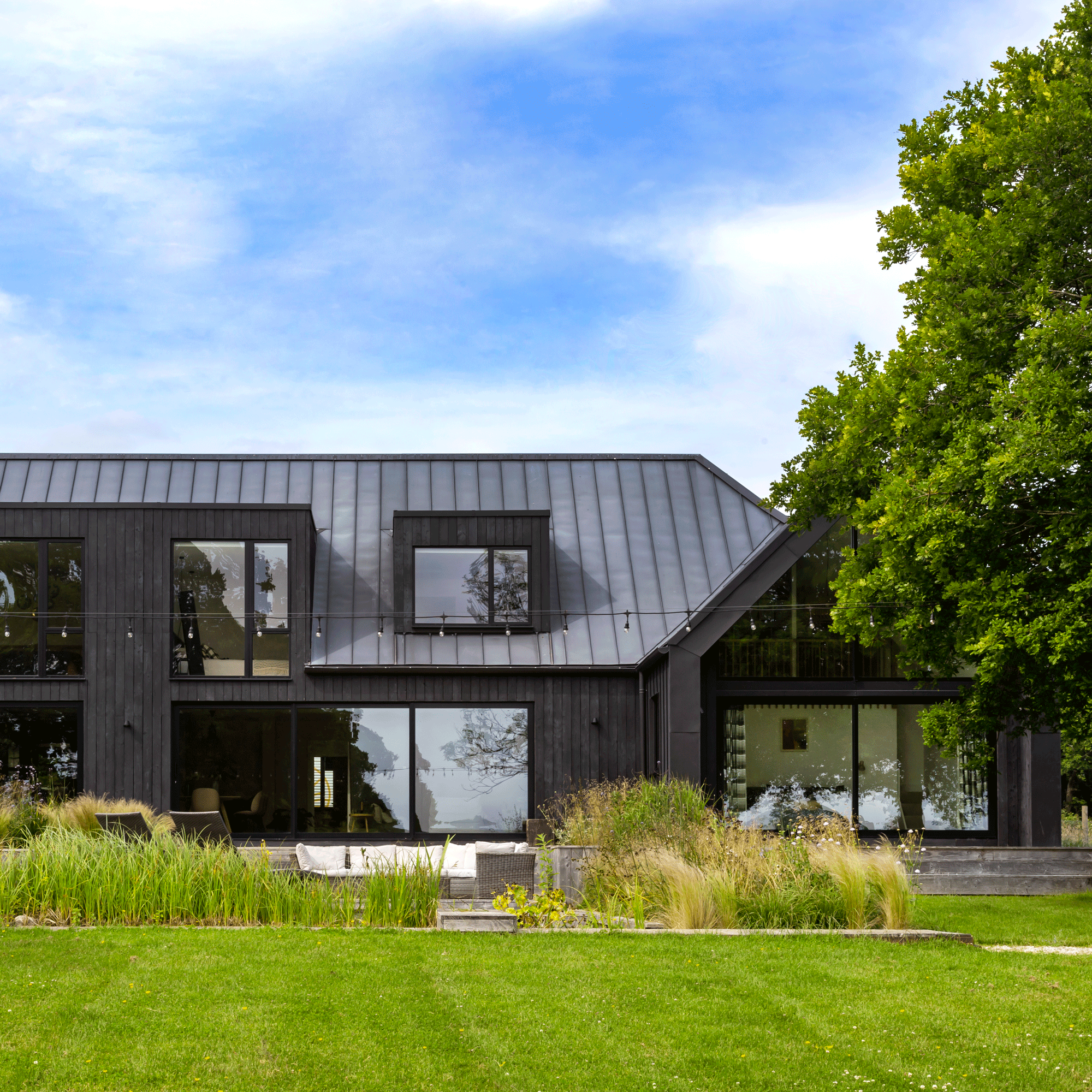 exterior new build with black timber cladding and stunning architectural glazing