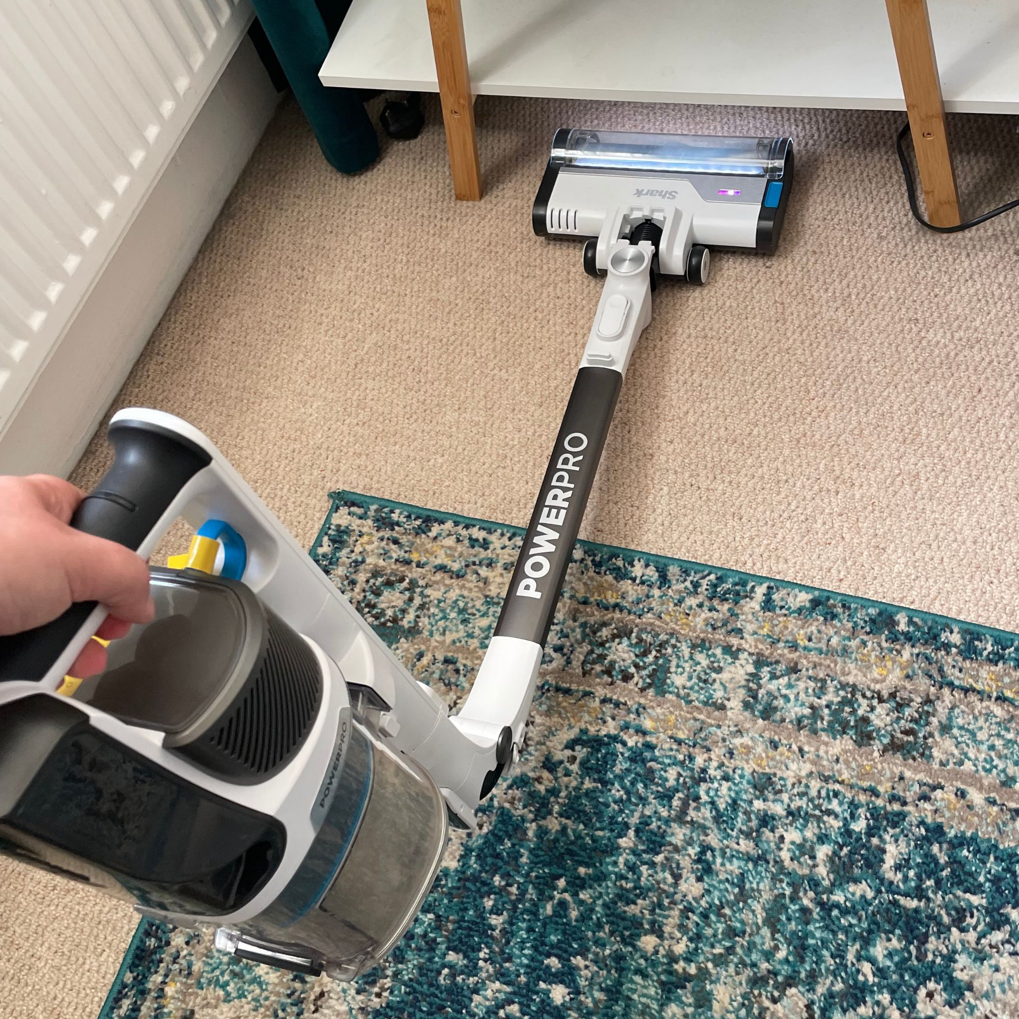 Using the flexology wand of the Shark Vacuum PowerPro to clean under furniture